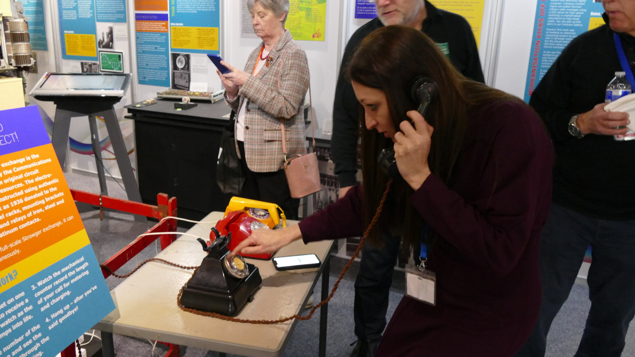 A visitor placing a call on the historic telephone demonstration