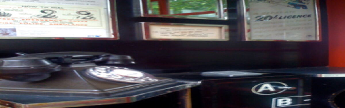 Interior of a kiosk showing the Button A and Button B coin mechanism and dialling instructions