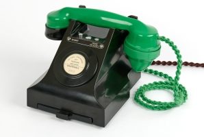 A scrambler telephone with its green handset.