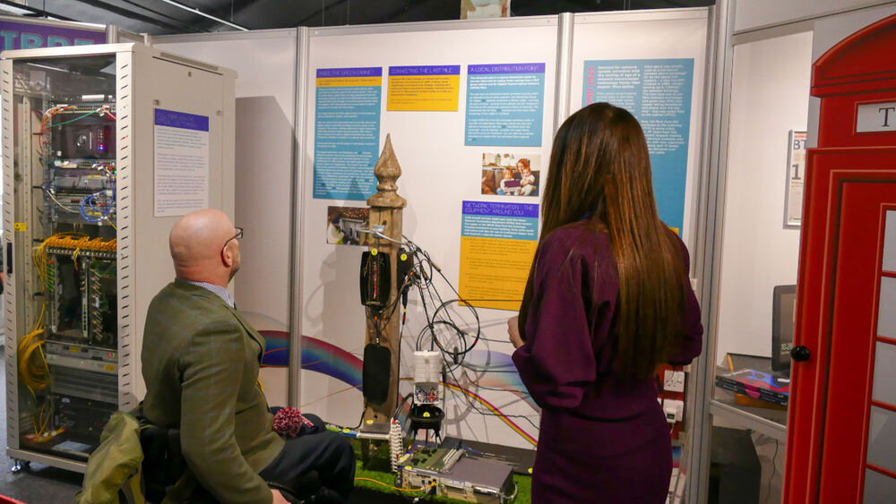 Visitors examining the fibre last-mile telegraph pole display